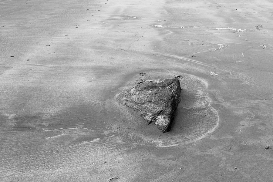 Infrared B&W Photo of Rock Sunk in Sandy Beach.